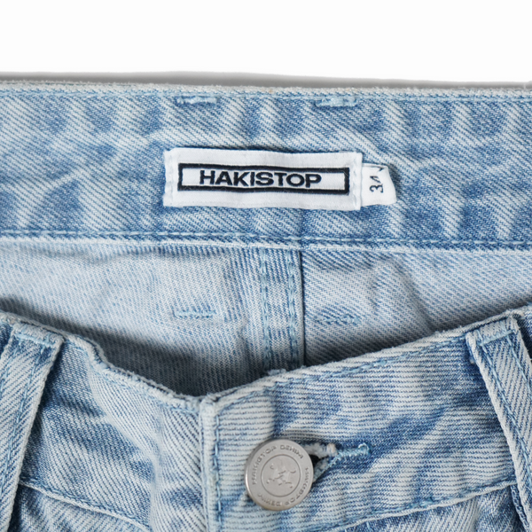 Close-up of a denim jacket with a Hakistop label.