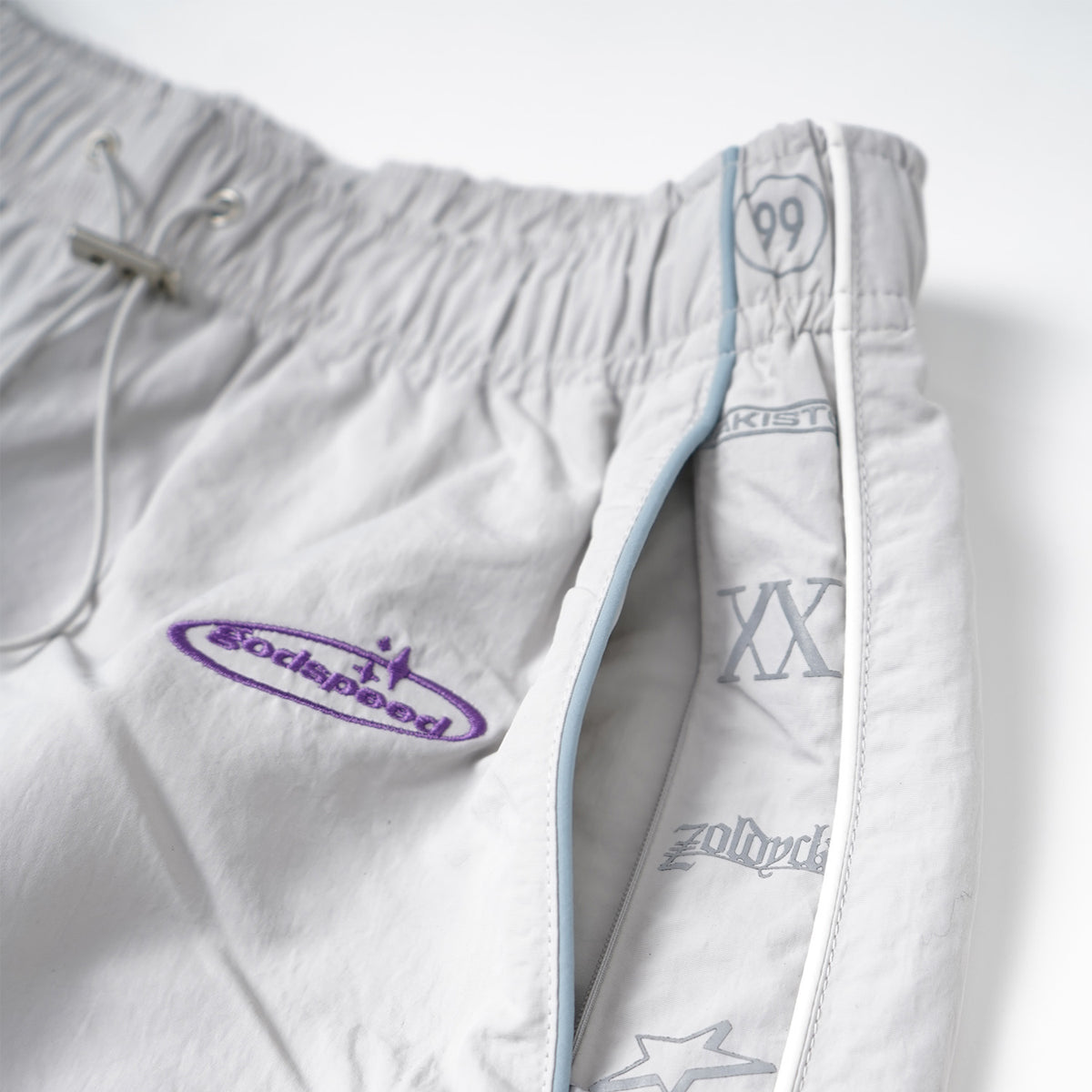 White shorts with branding on a white background