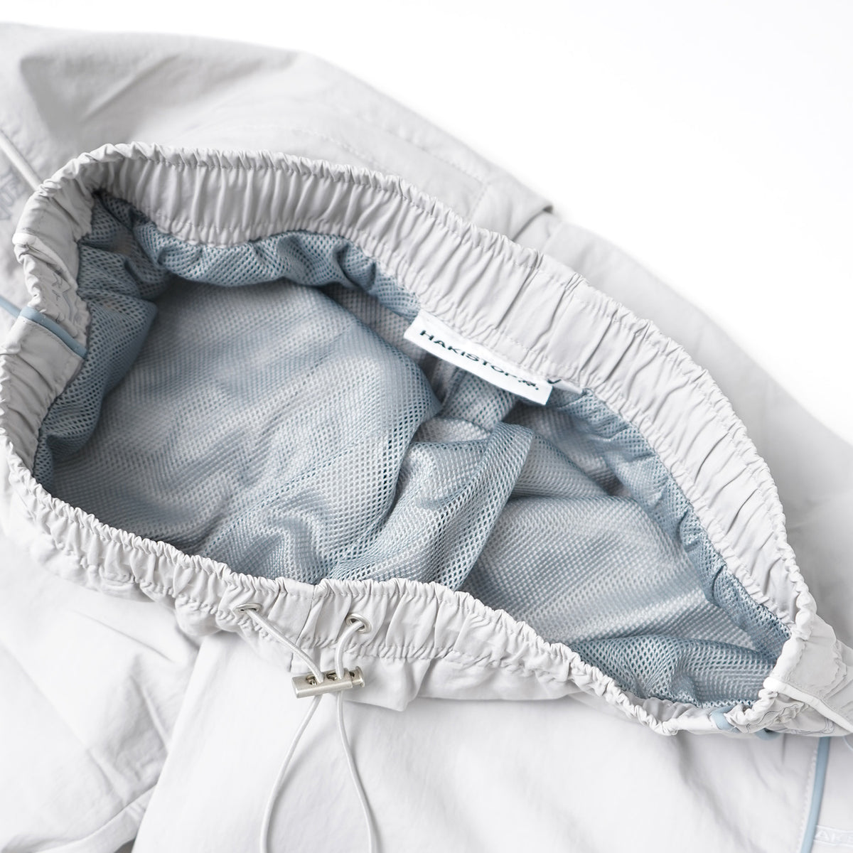 Close-up of a baby diaper with mesh backing and brand label.