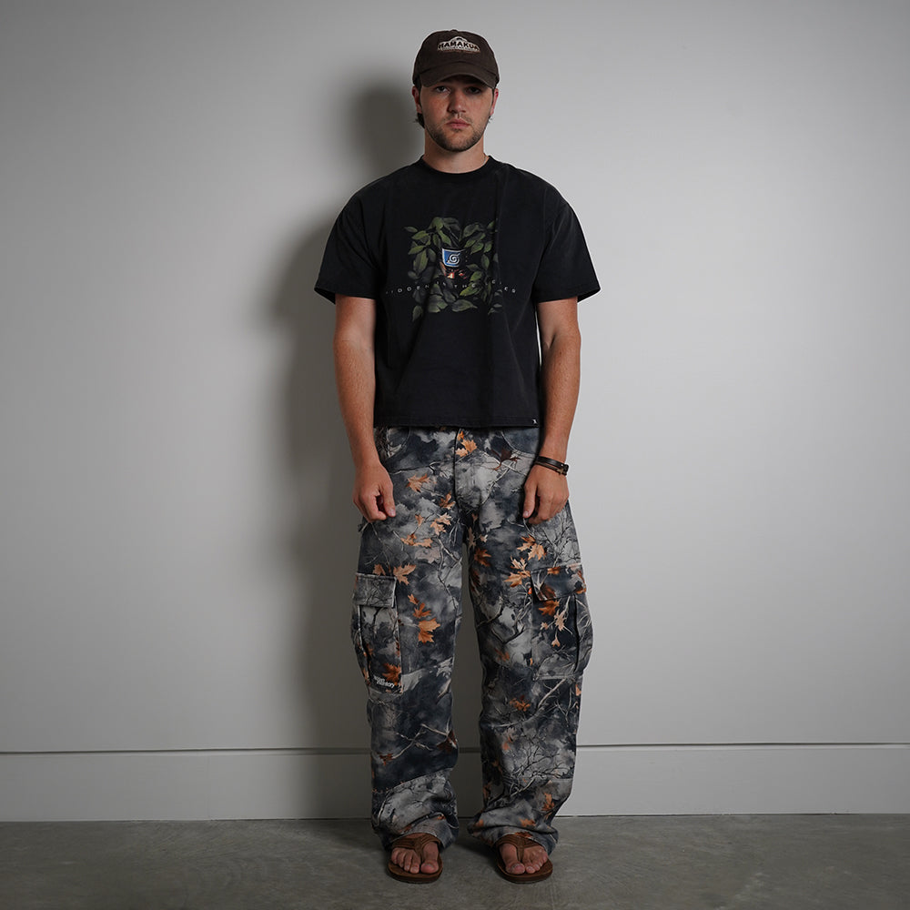 Hidden in the Leaves Tee in charcoal black with anime graphic print, front view on model