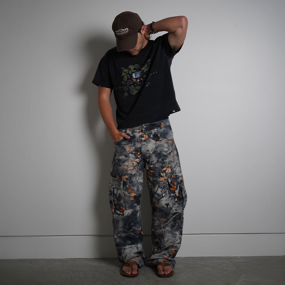 Hidden in the Leaves Tee in charcoal black with anime graphic print, front view on model