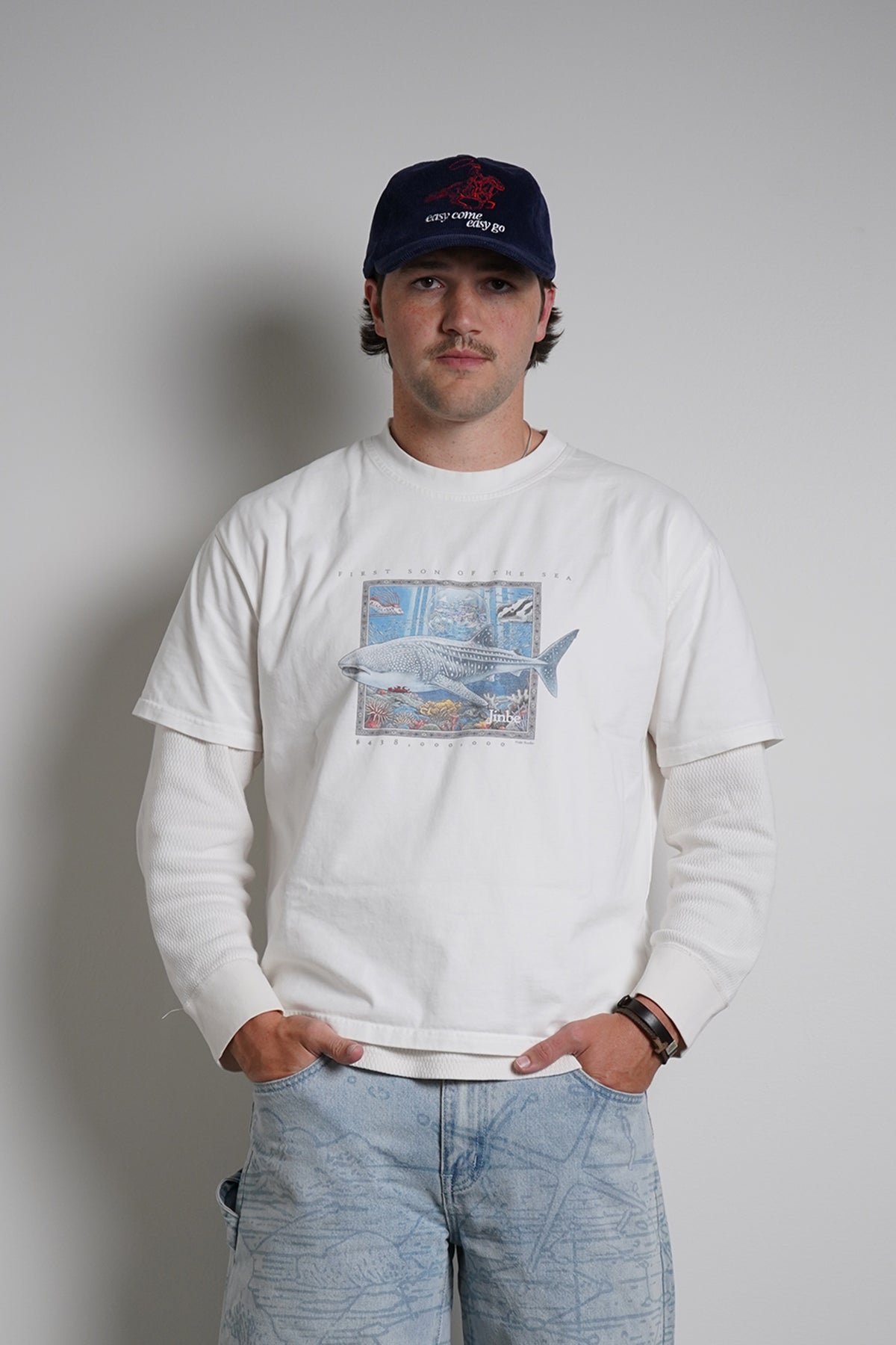 White First Son of The Sea Tee with whale shark graphic, full-length front view on model in light blue jeans