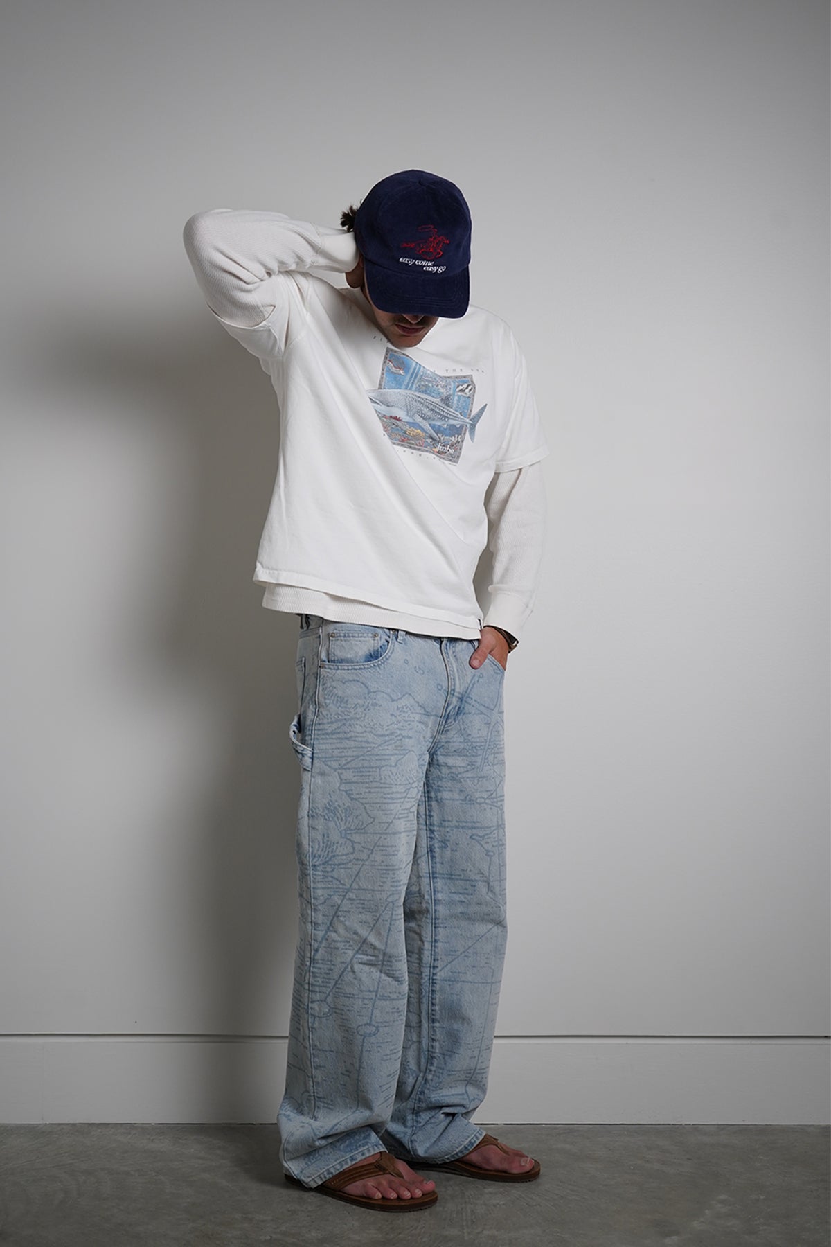White First Son of The Sea Tee with whale shark graphic, full-length front view on model in light blue jeans