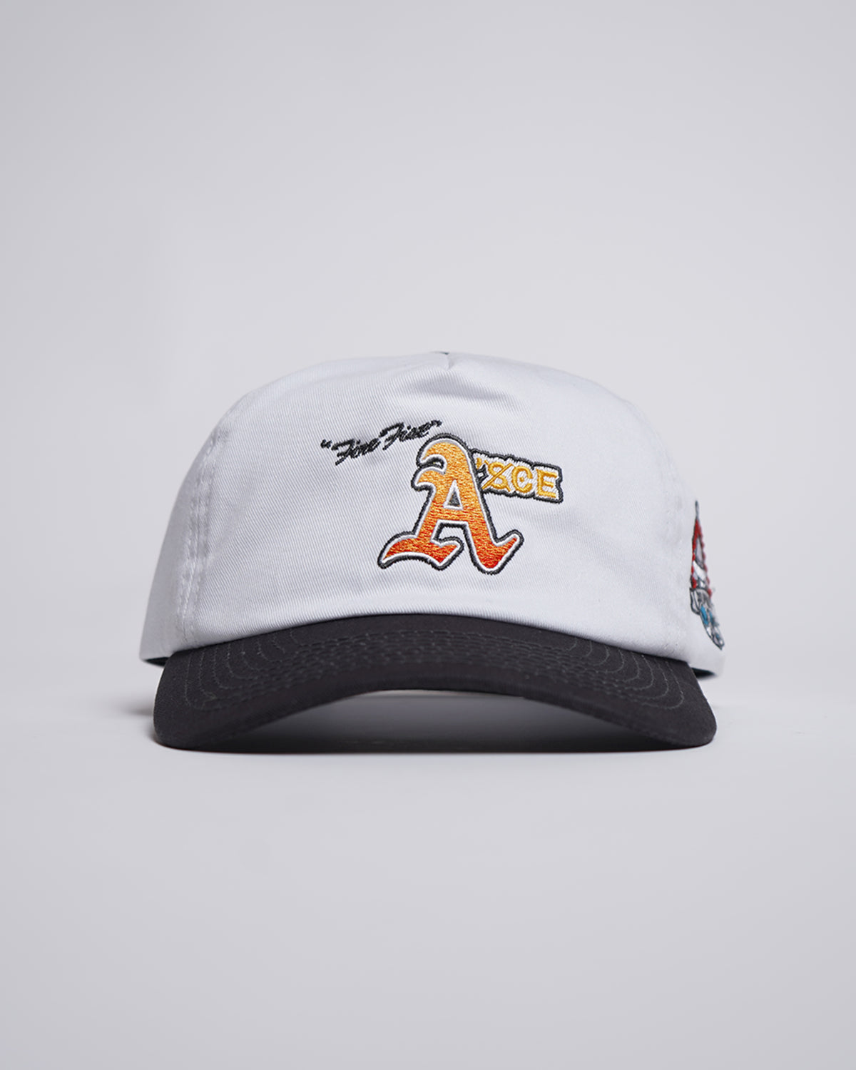 Fire Fist Hat with white crown and black visor, front view displaying orange embroidered logo.