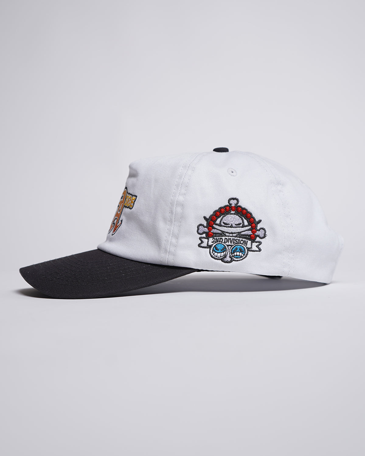 White Fire Fist Hat with black brim, side view showing embroidered skull and 2ND DIVISION banner