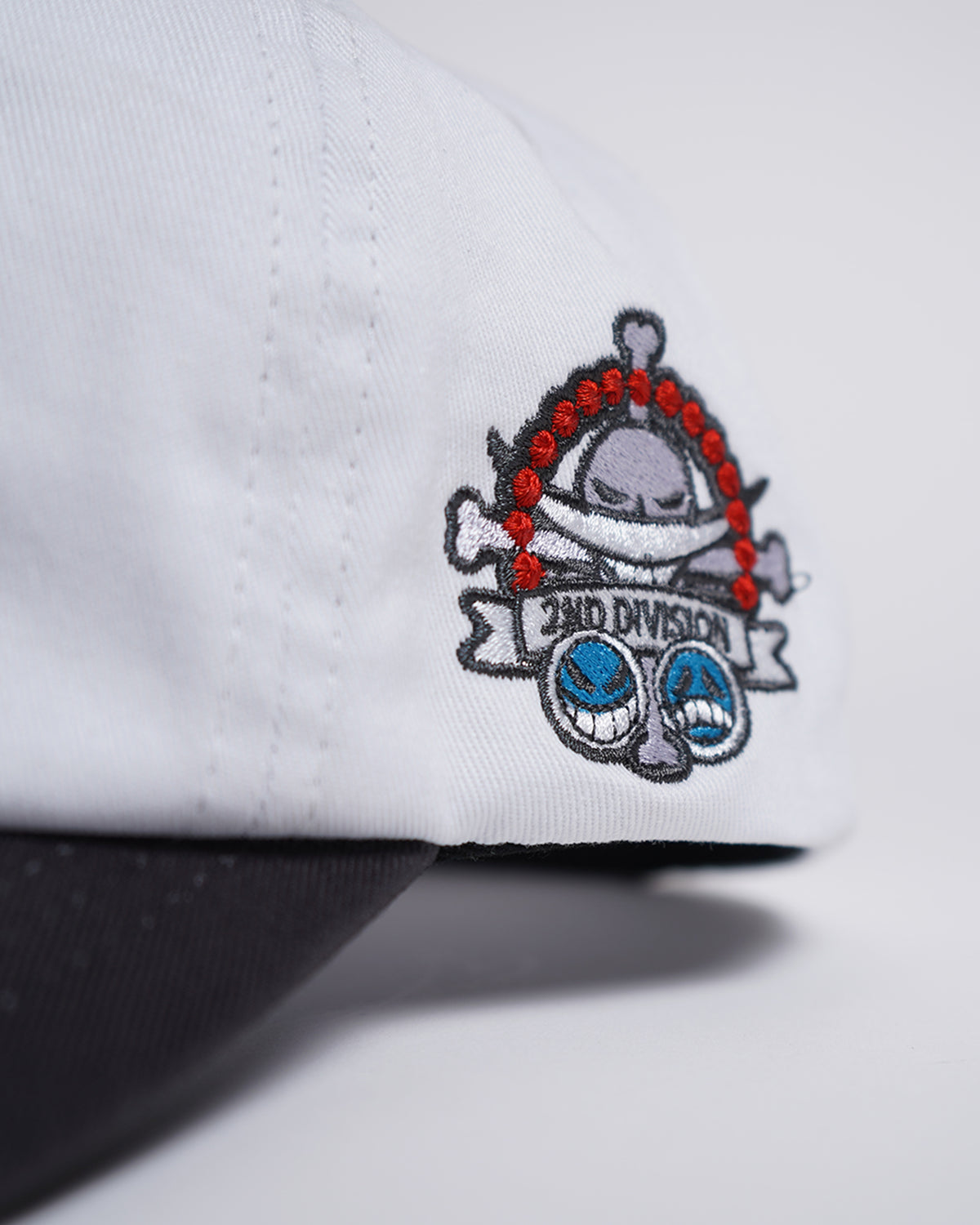 Close-up of the Fire Fist Hat side embroidery showing skull with crossbones and 2ND DIVISION banner