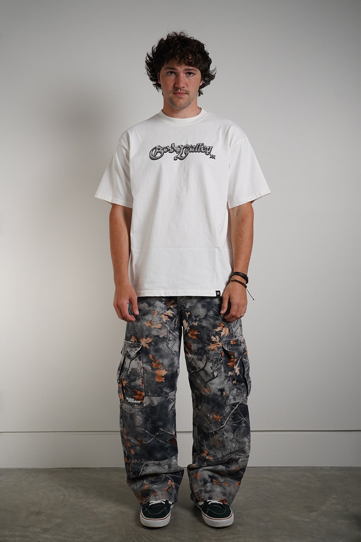 Hidden Inventory Pants in blue denim with orange leaf print, front view in model