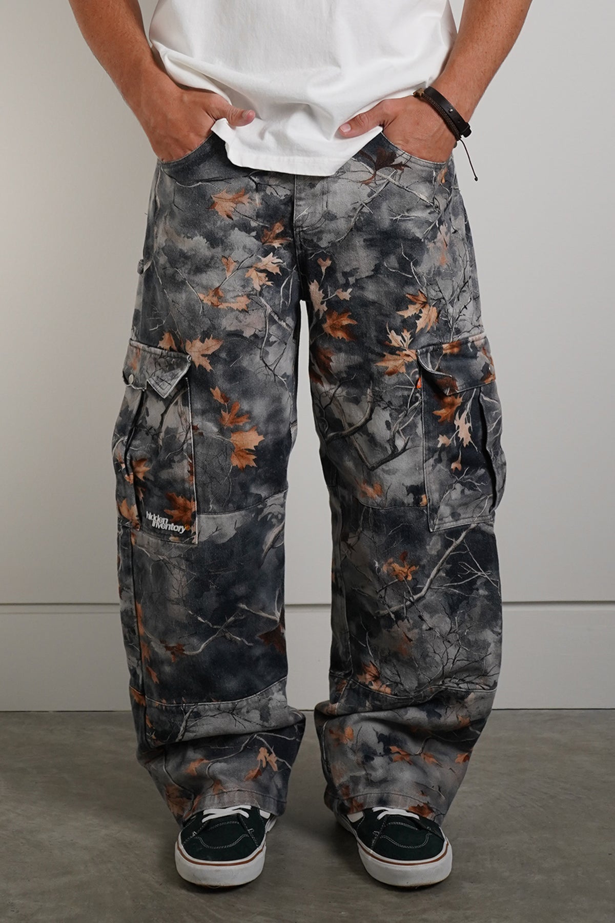 Hidden Inventory Pants in blue denim with orange leaf print, front view in model