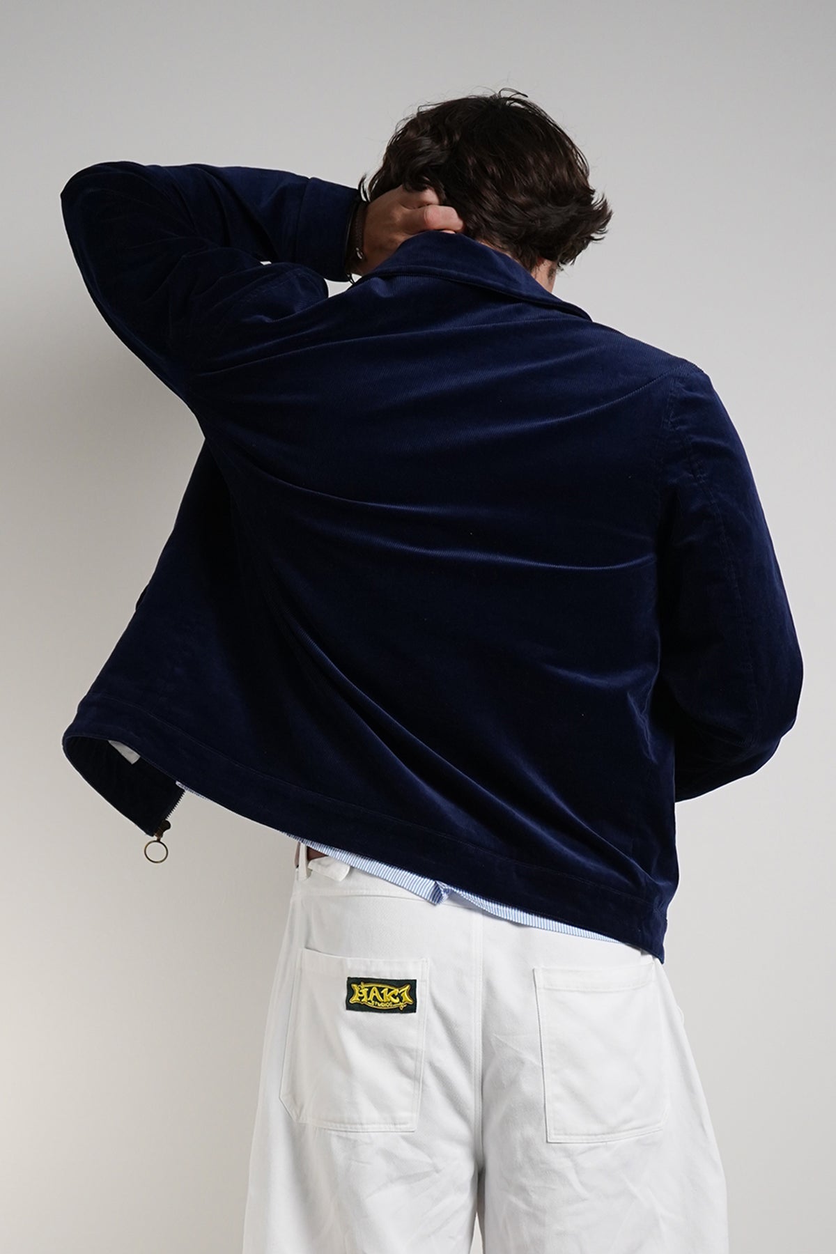 Navy Queen of Curses Jacket, back view on model with blue shirt.