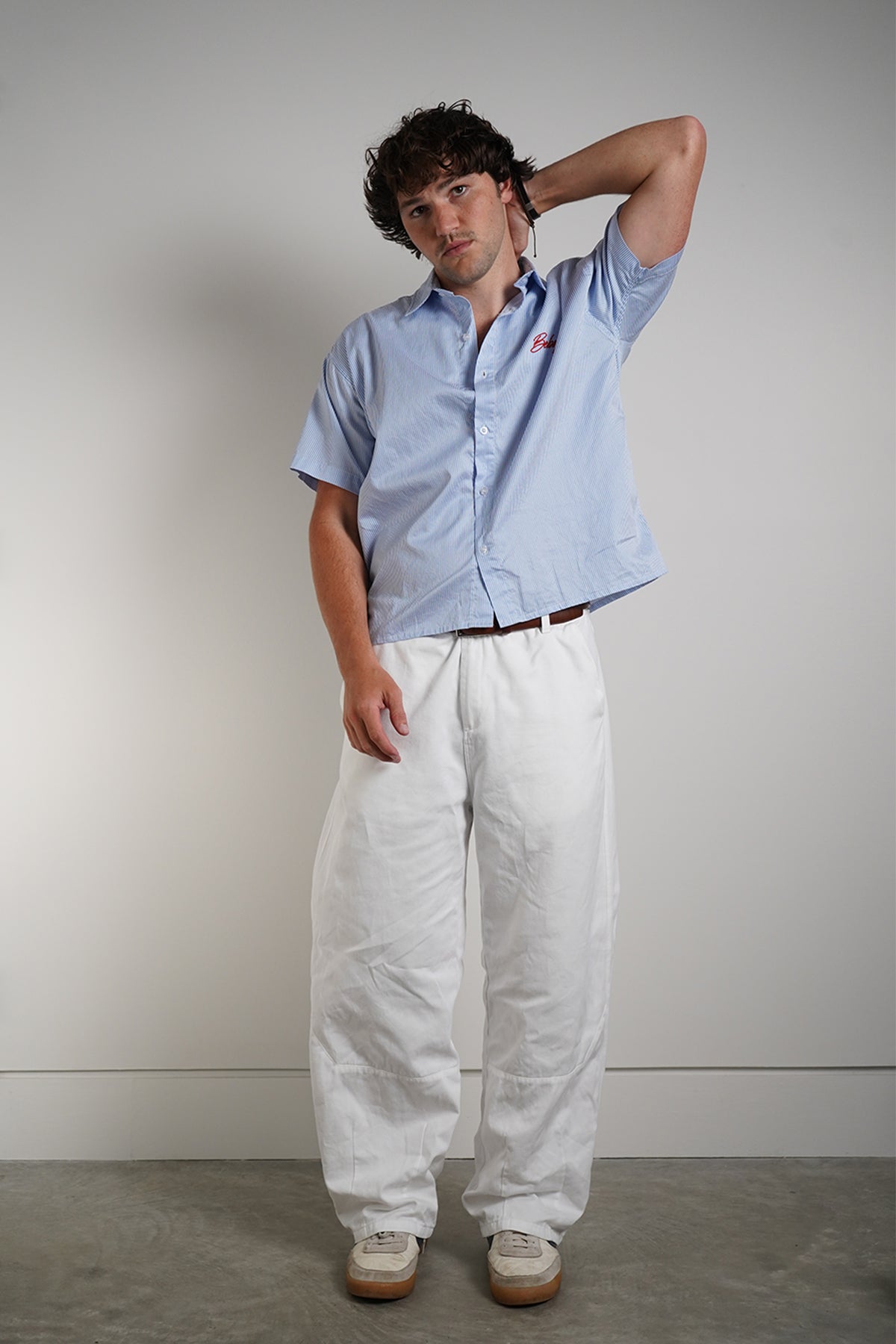 Bebop Work Shirt in light blue pinstripe with red embroidered logo, front view on model.