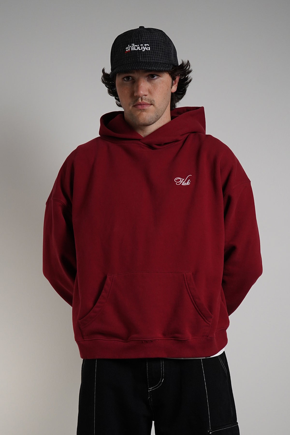 Come Over Hoodie in burgundy with embroidered "Haki" logo, front view on model
