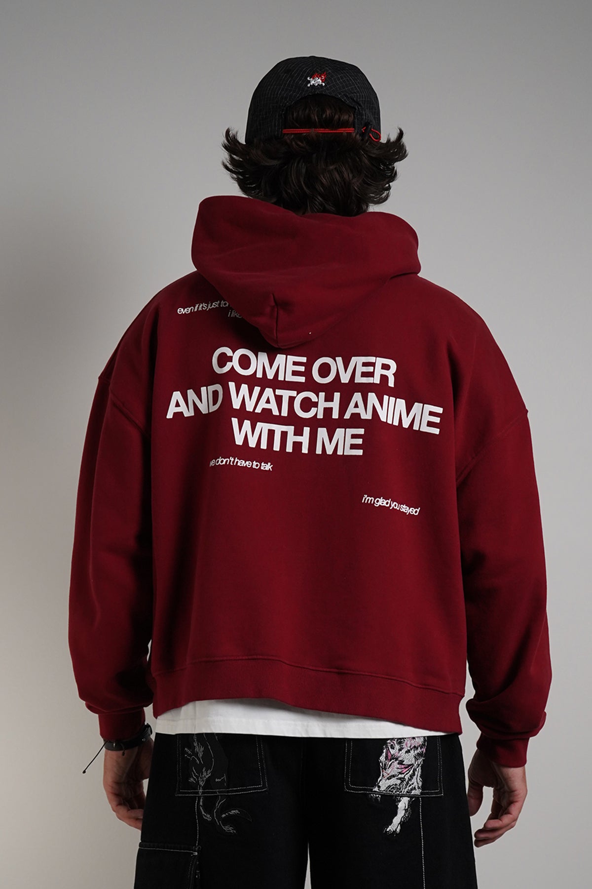 Burgundy Come Over Hoodie with white back graphic, rear view on model with black cap