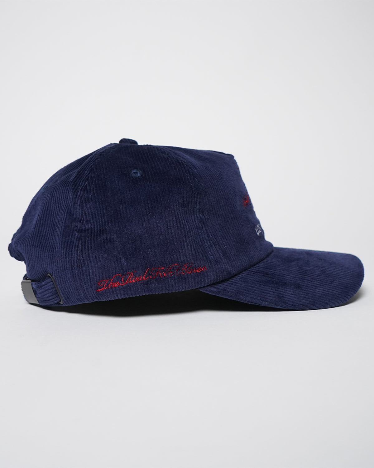 Easy Come Easy Go Hat in midnight blue corduroy with red embroidered graphic, side view