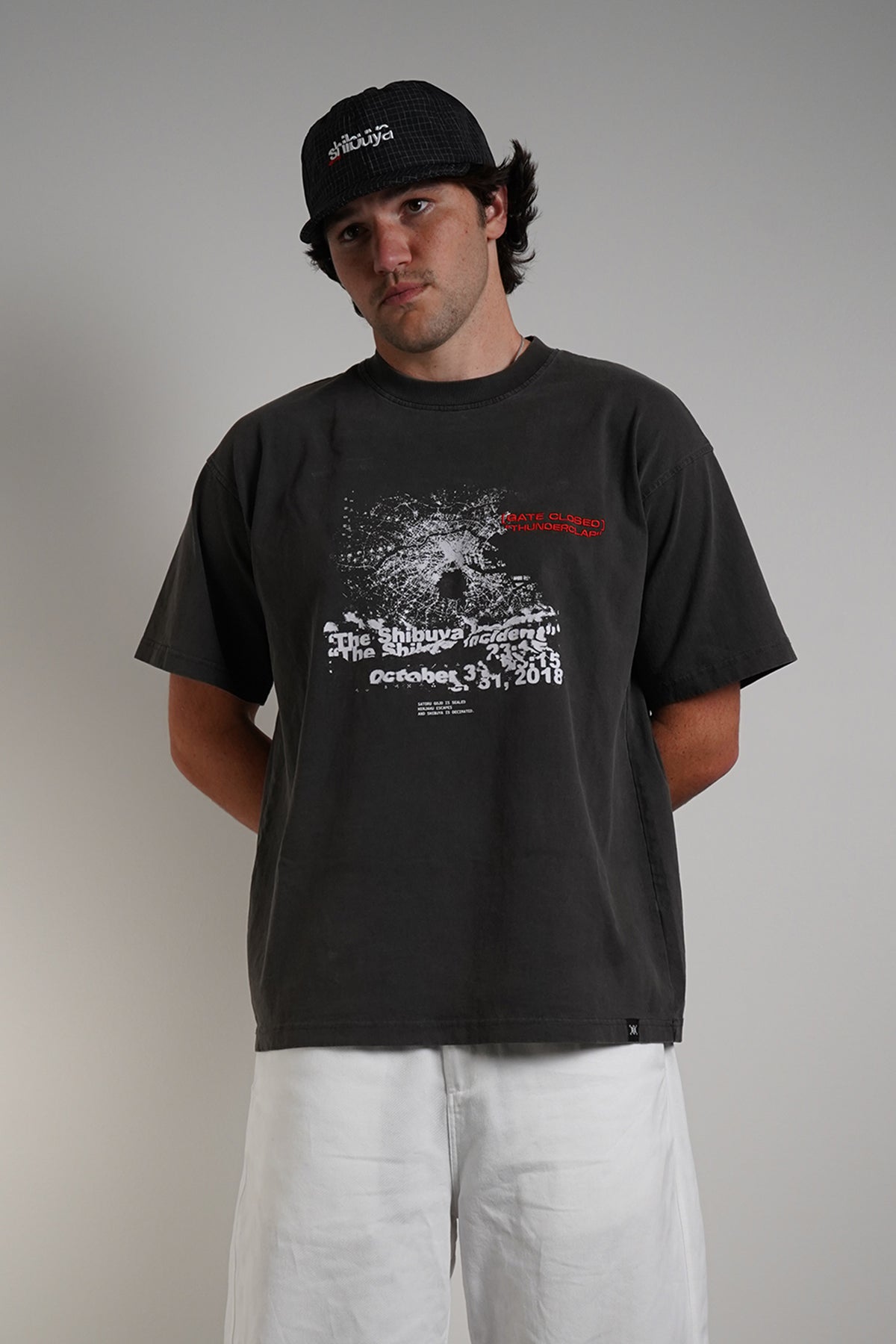 Charcoal Shibuya Incident Tee with dispersing graphic and date print, front view on model.