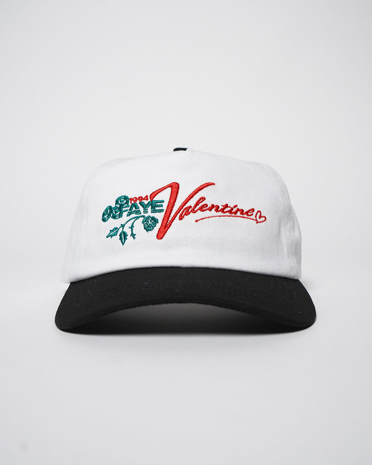 White Valentine Hat with black visor and embroidered green roses and red Valentine script, front view