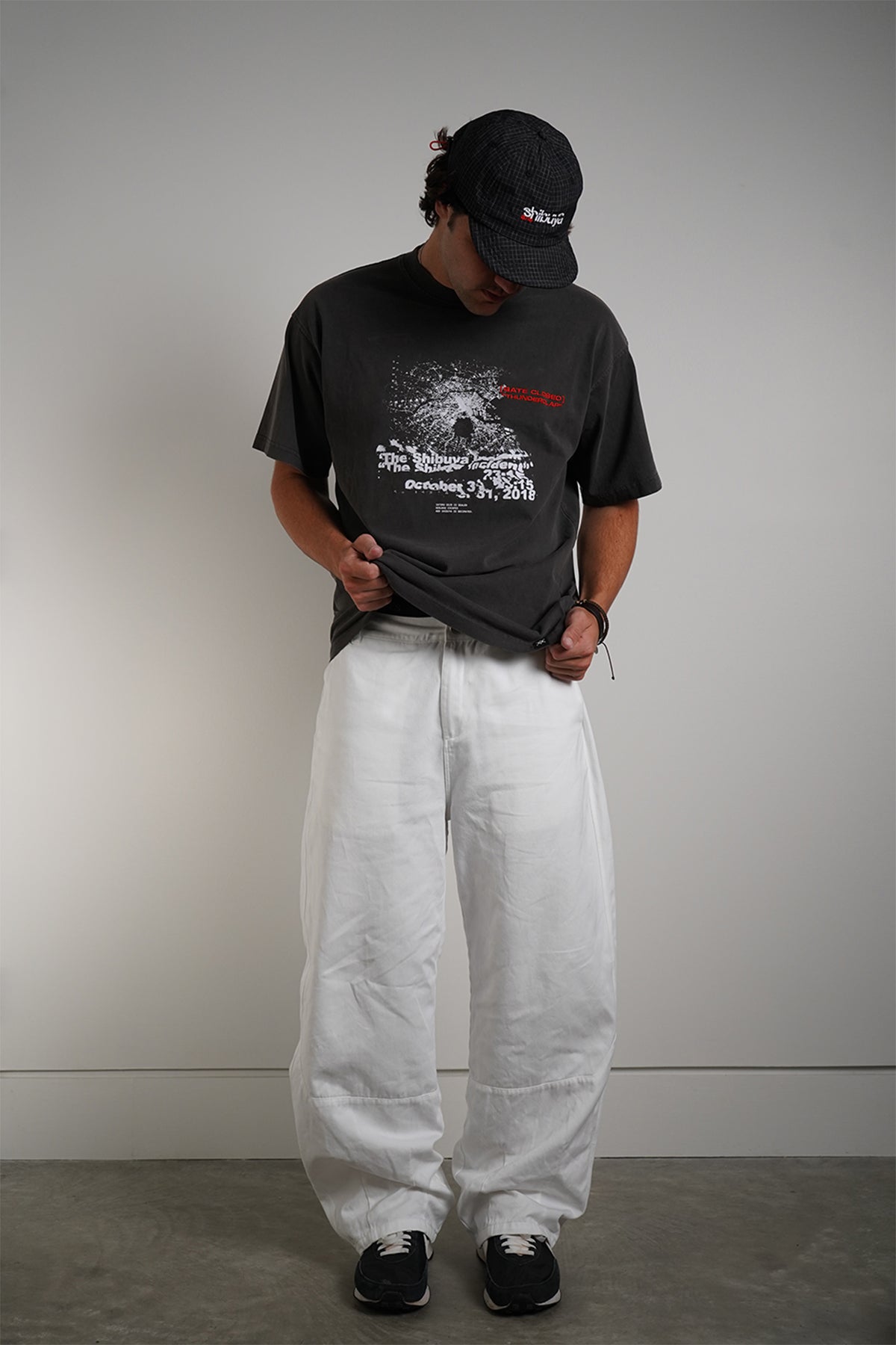 Charcoal Shibuya Incident Tee with dispersing graphic and date print, front view on model.