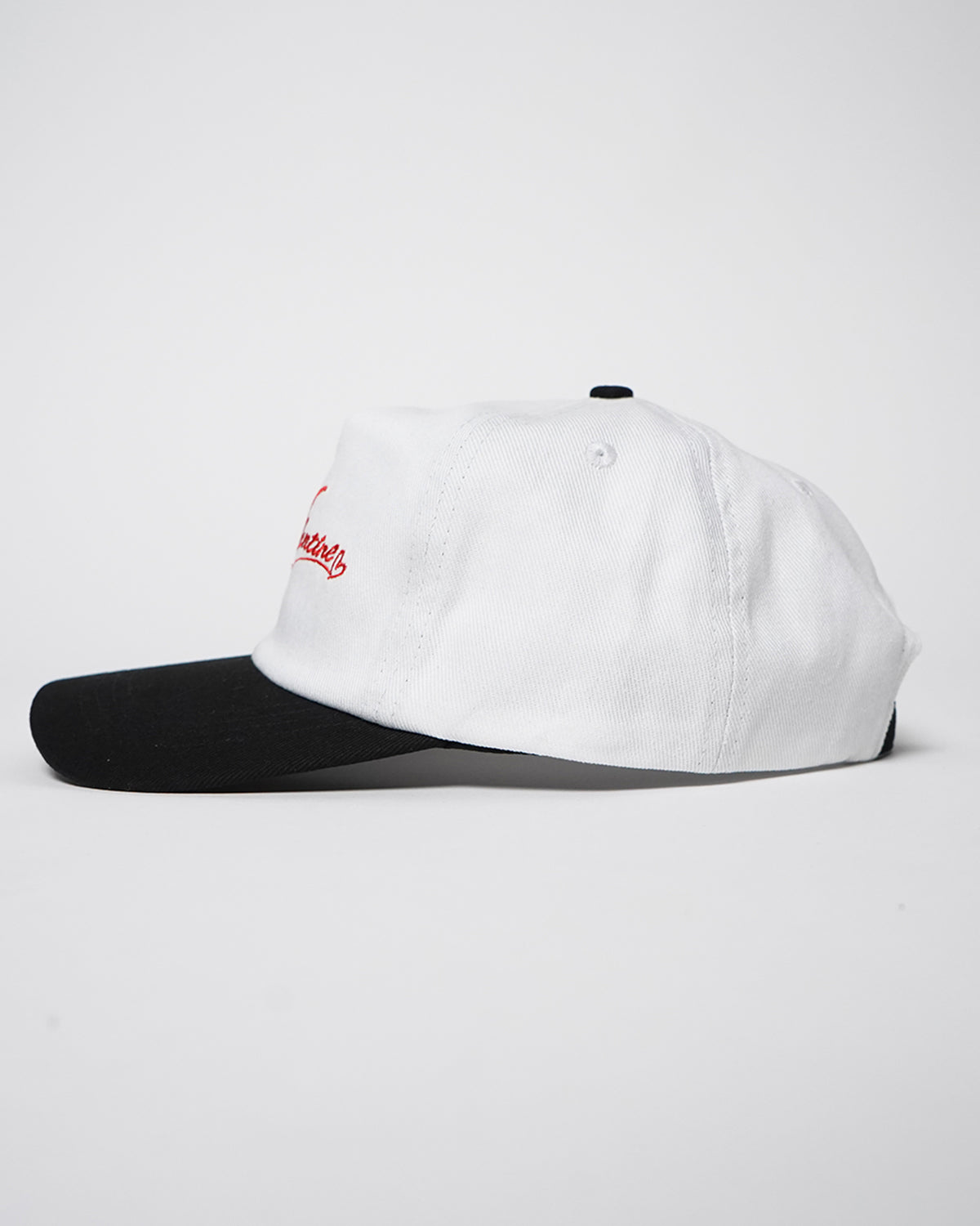 White and black Valentine Hat with red embroidered crown logo, side view