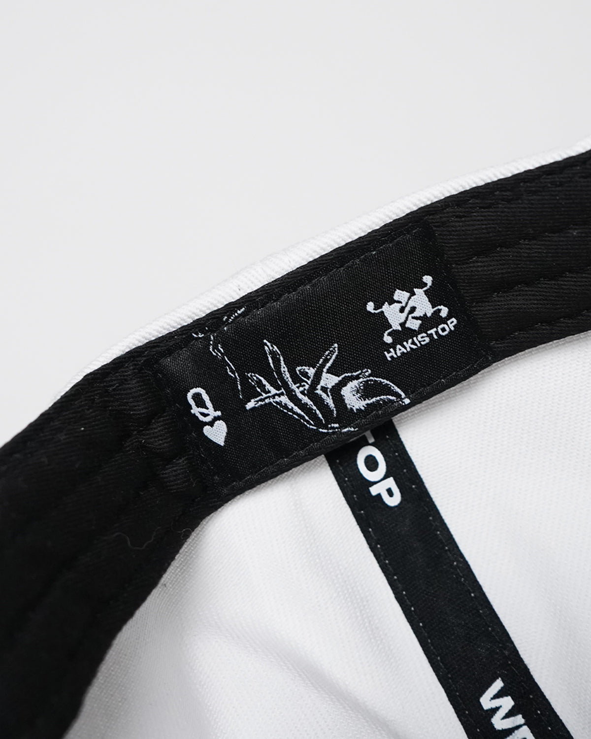 Interior band of the Valentine Hat with woven HAKISTOP label and Q-of-hearts hand illustration label