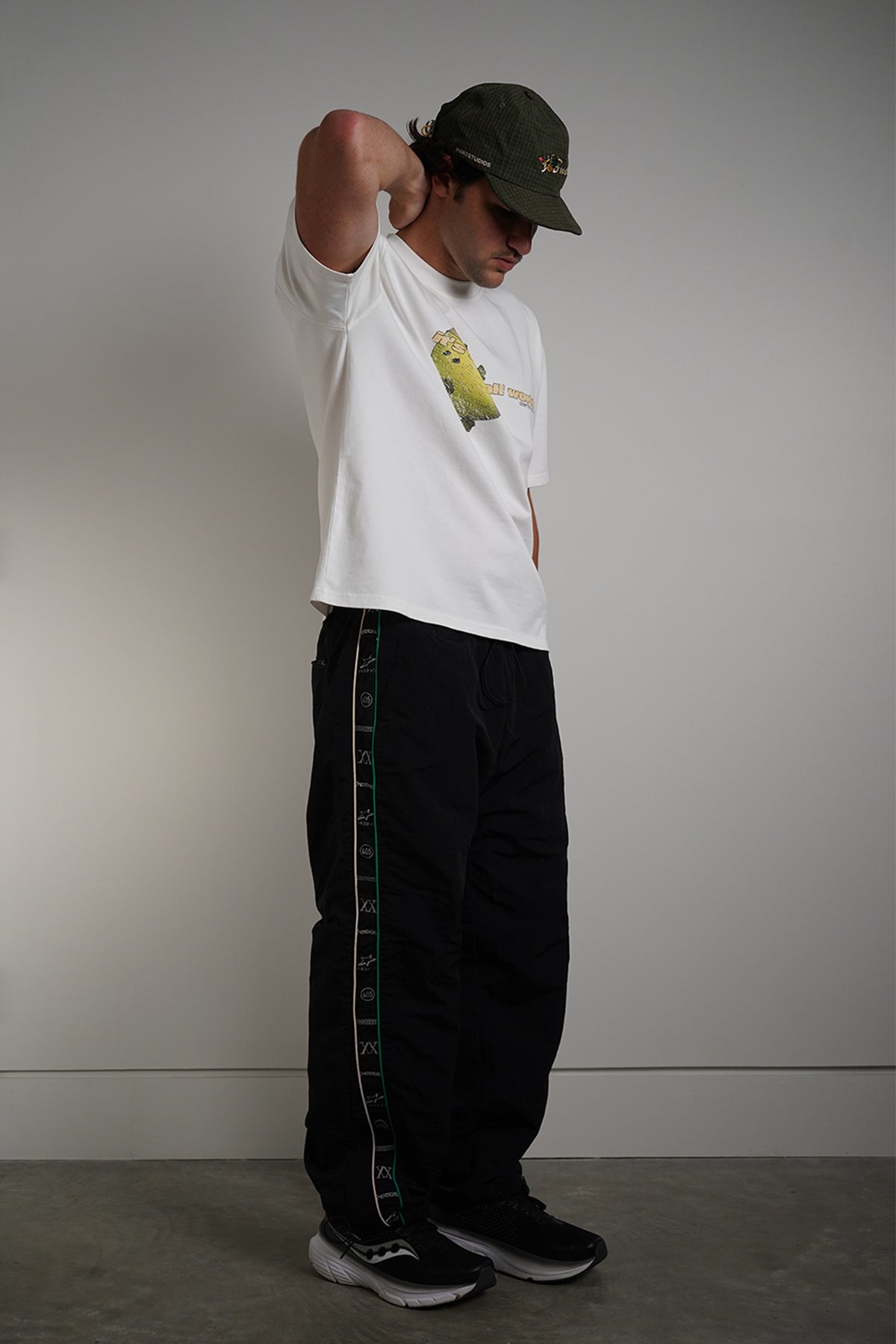  White Dragonball 40th Anniversary Tee with yellow graphic print, side view on model
