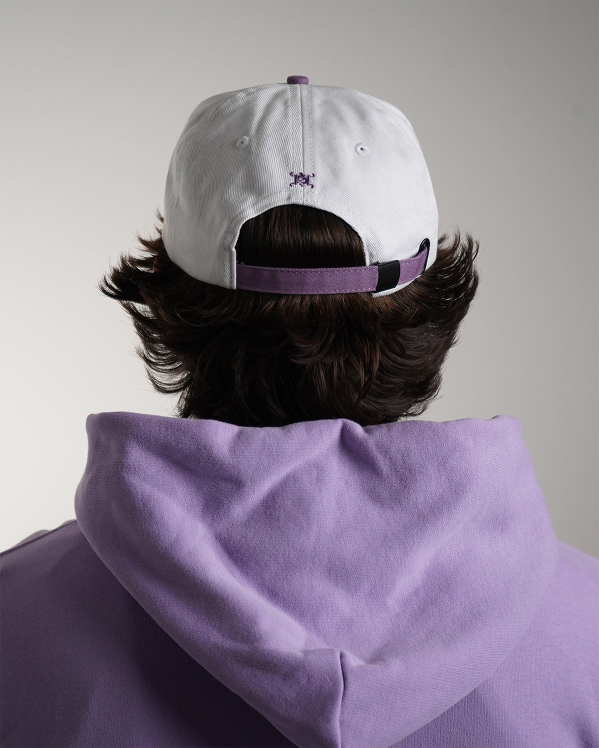 Guardian Deity Hat in white and purple with embroidered tiger graphic, back view on model.