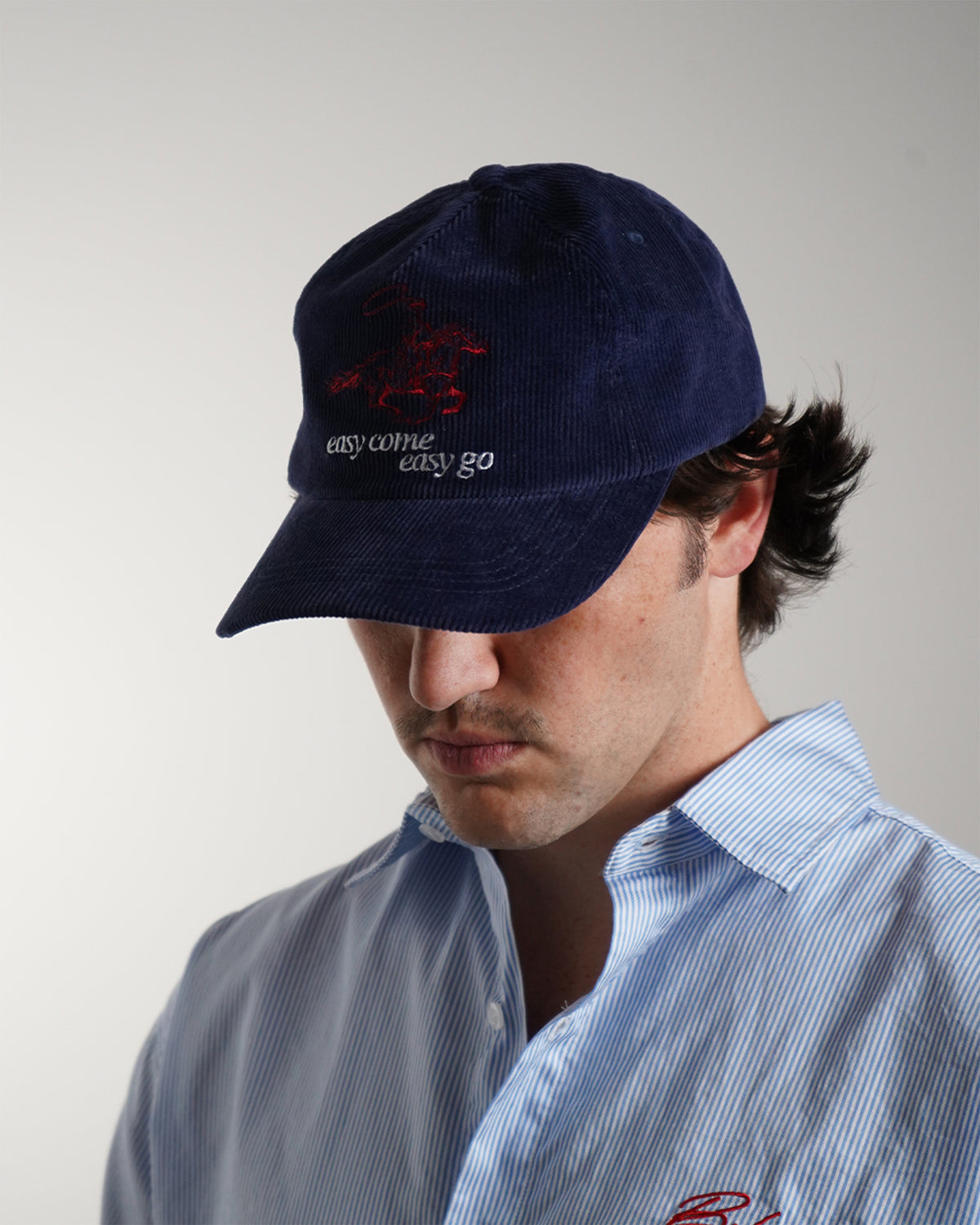 Easy Come Easy Go Hat in midnight blue corduroy with red embroidered graphic, front view