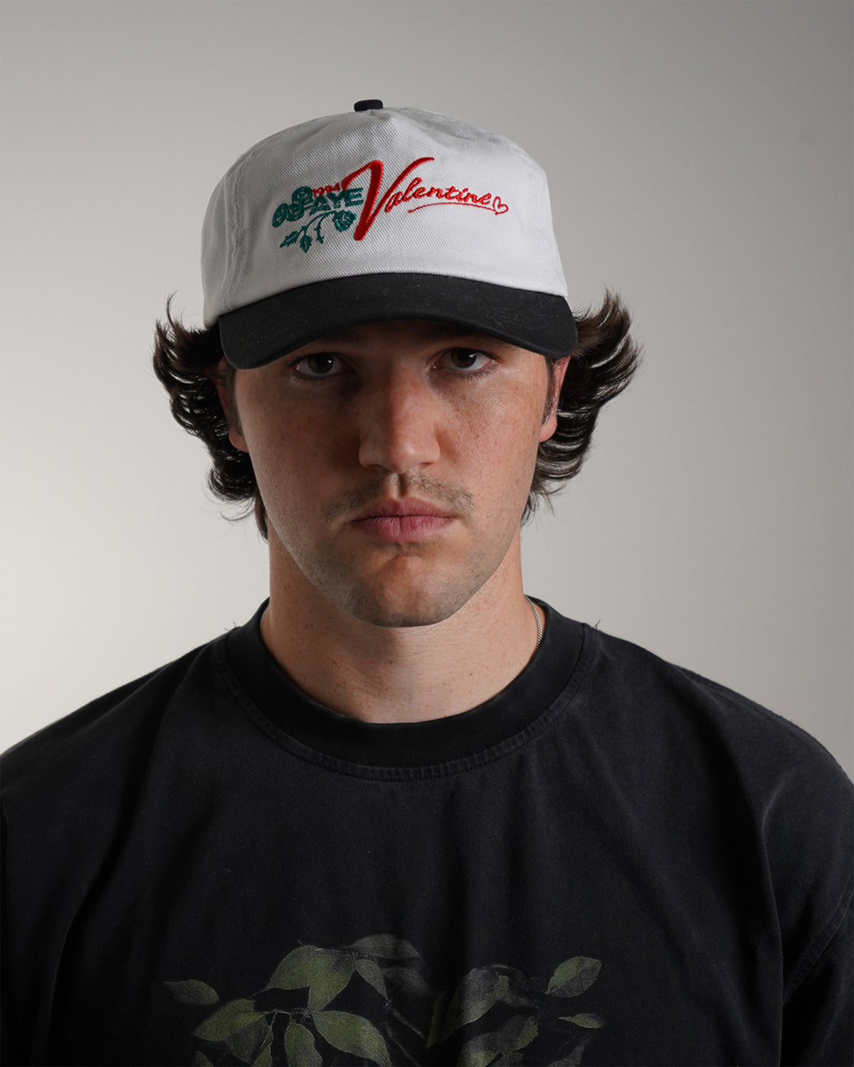 White Valentine Hat with red logo graphic, front view on model