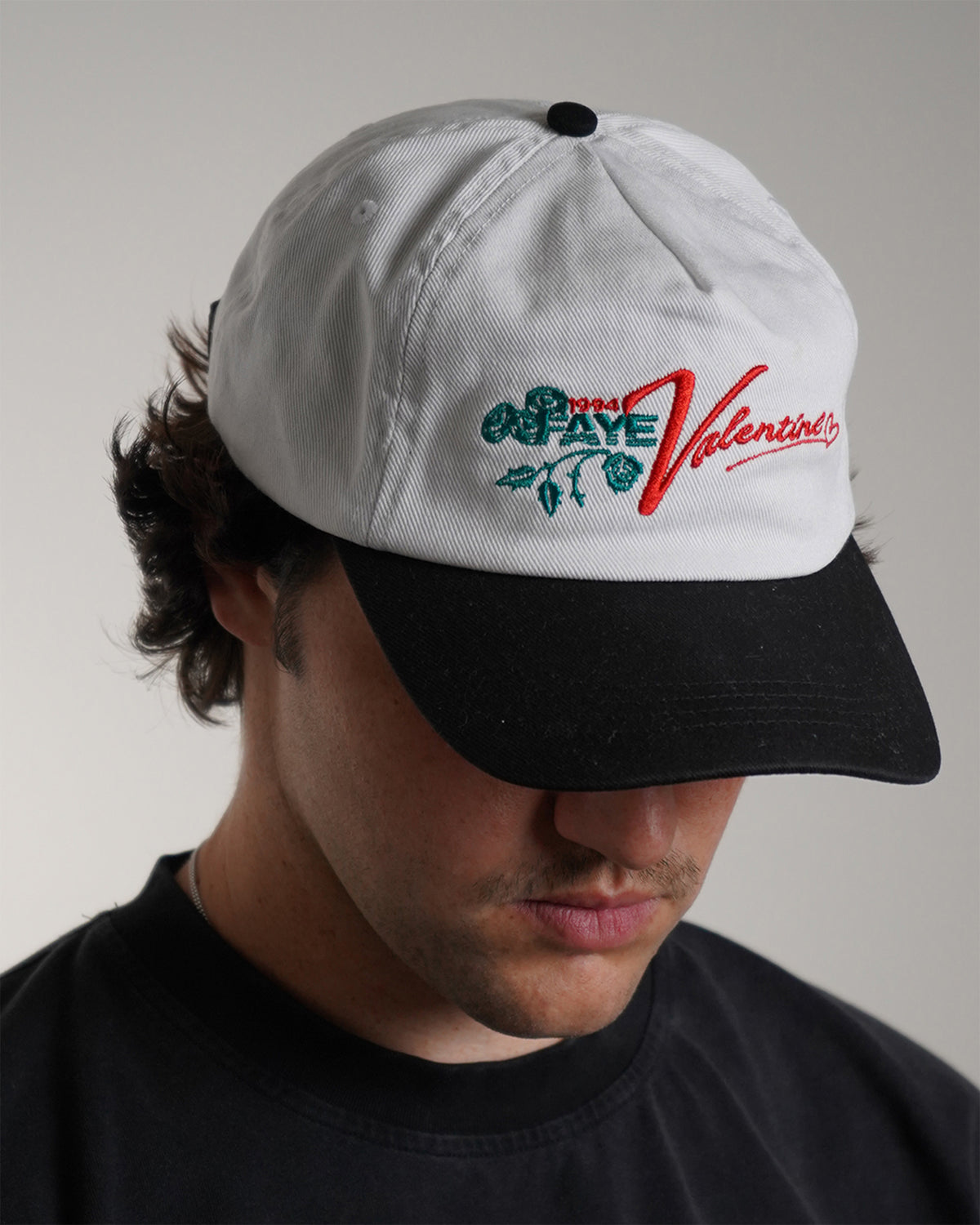 White Valentine Hat with red logo graphic, front view on model