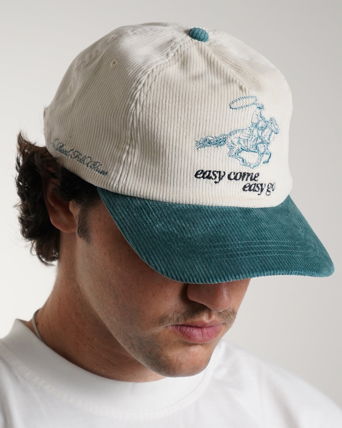 Easy Come Easy Go Hat (Tennis Green) in cream with teal cowboy graphic and brim, front view on model