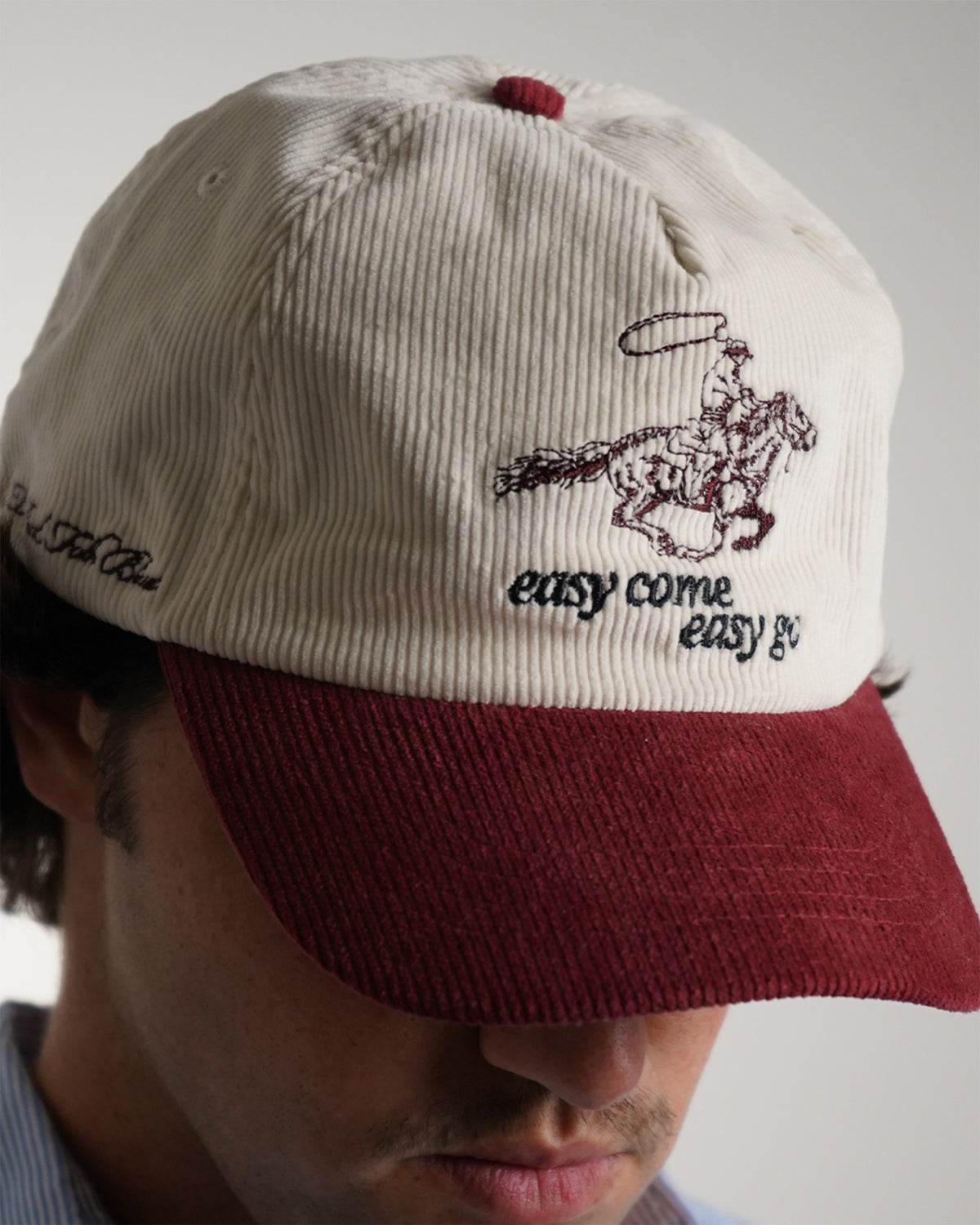 Easy Come Easy Go Hat in cream and burgundy with cowboy graphic, front view on model