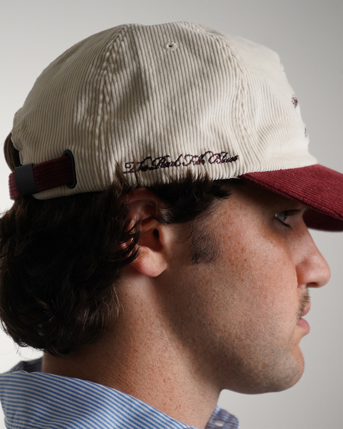 Easy Come Easy Go Hat in cream and burgundy with cowboy graphic, side view on model