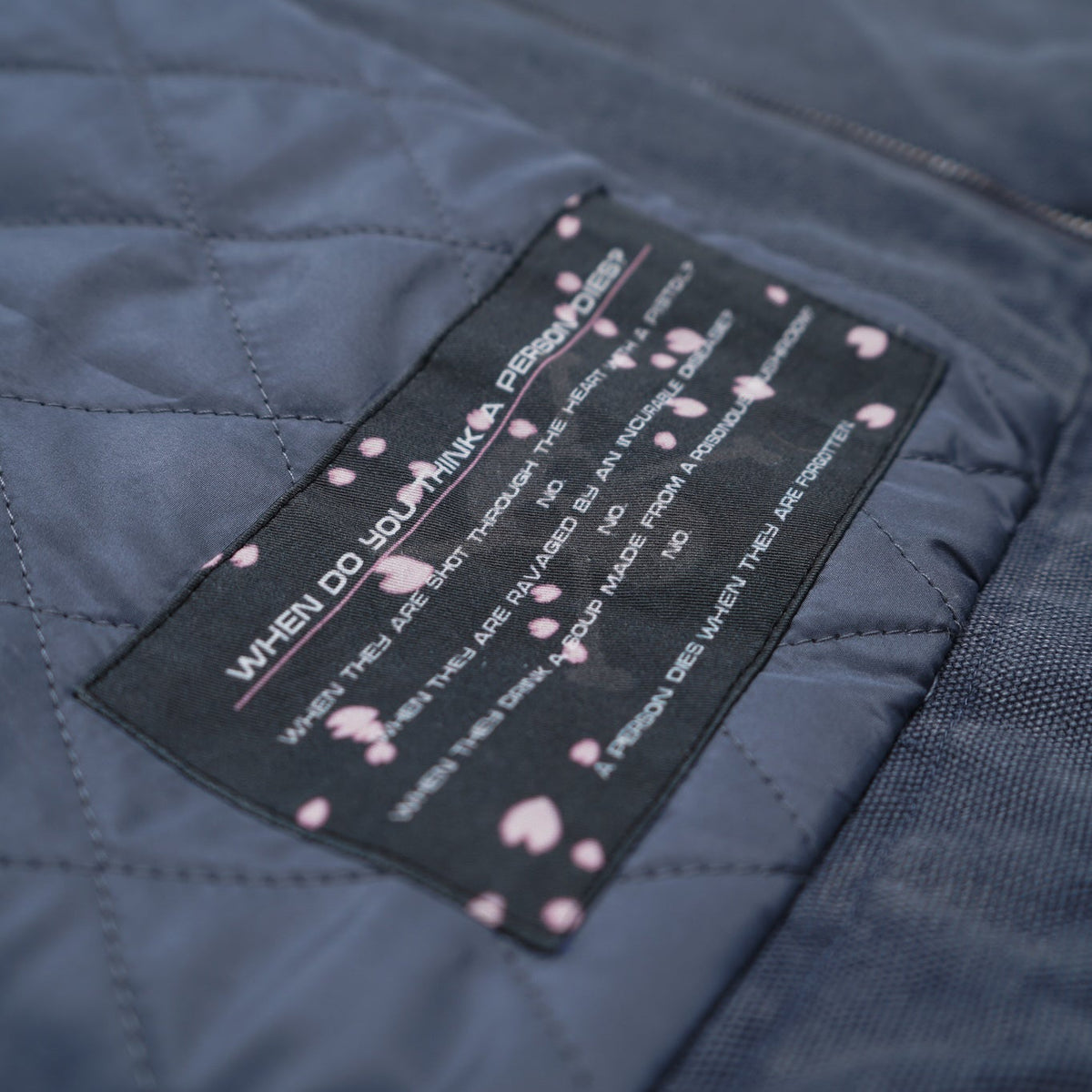 Close-up of a label on a dark blue quilted jacket