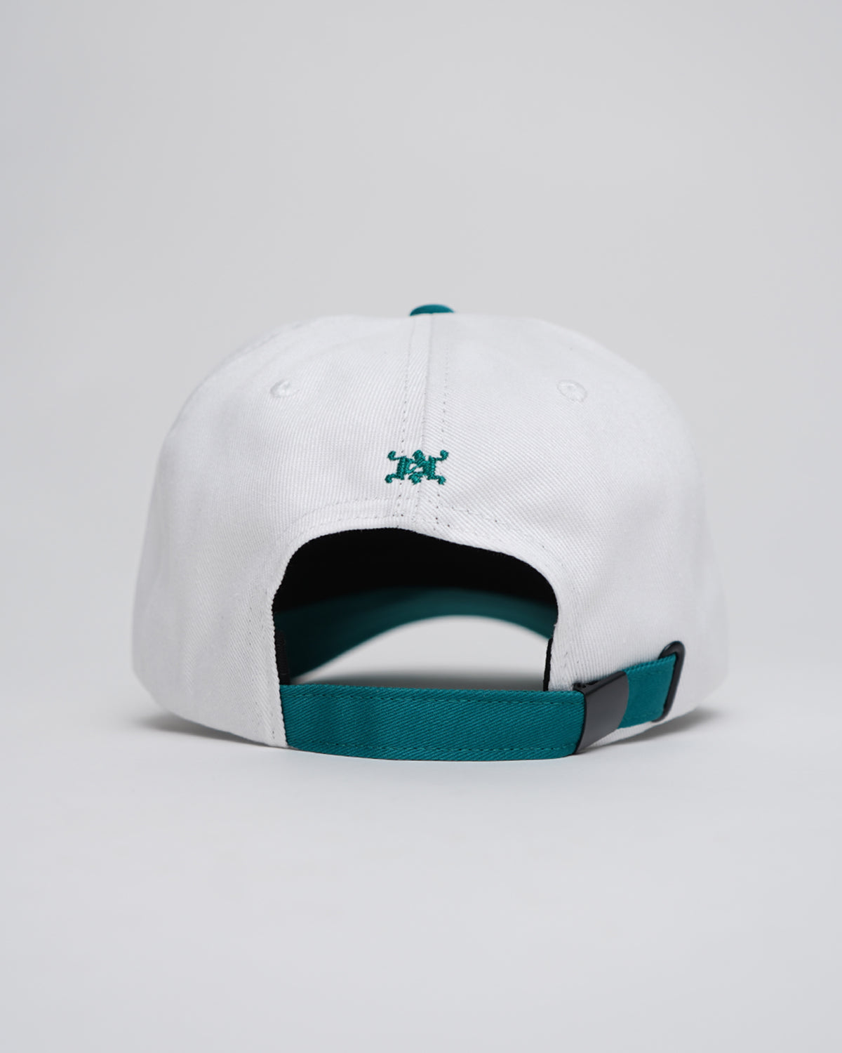 White and teal Greed Island Hat with embroidered logo, back angle view