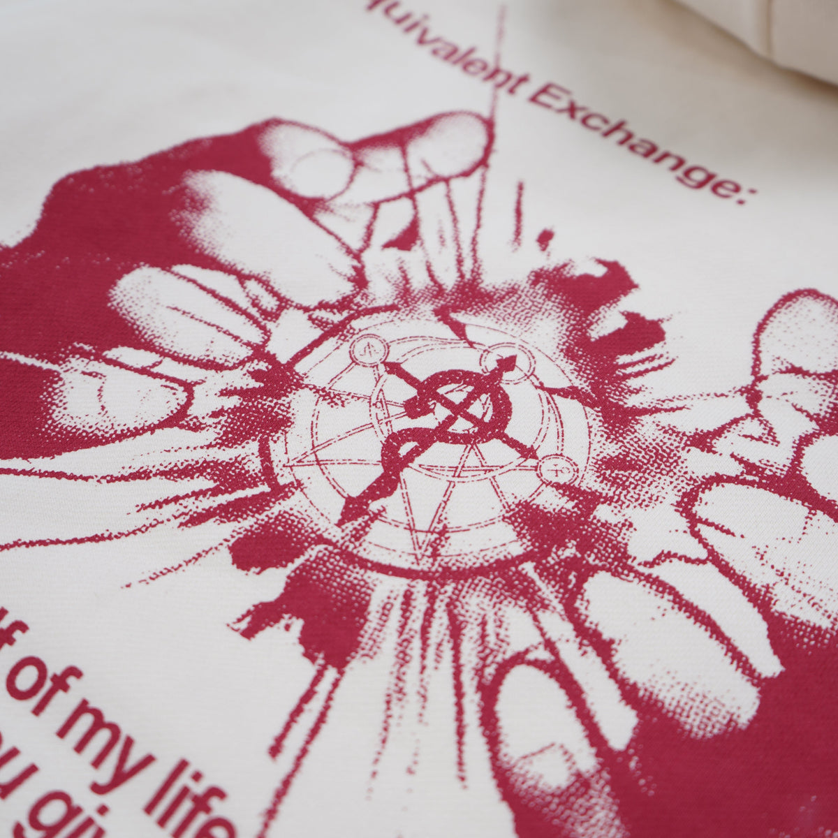 White pillow with red graphic design and text on a white background