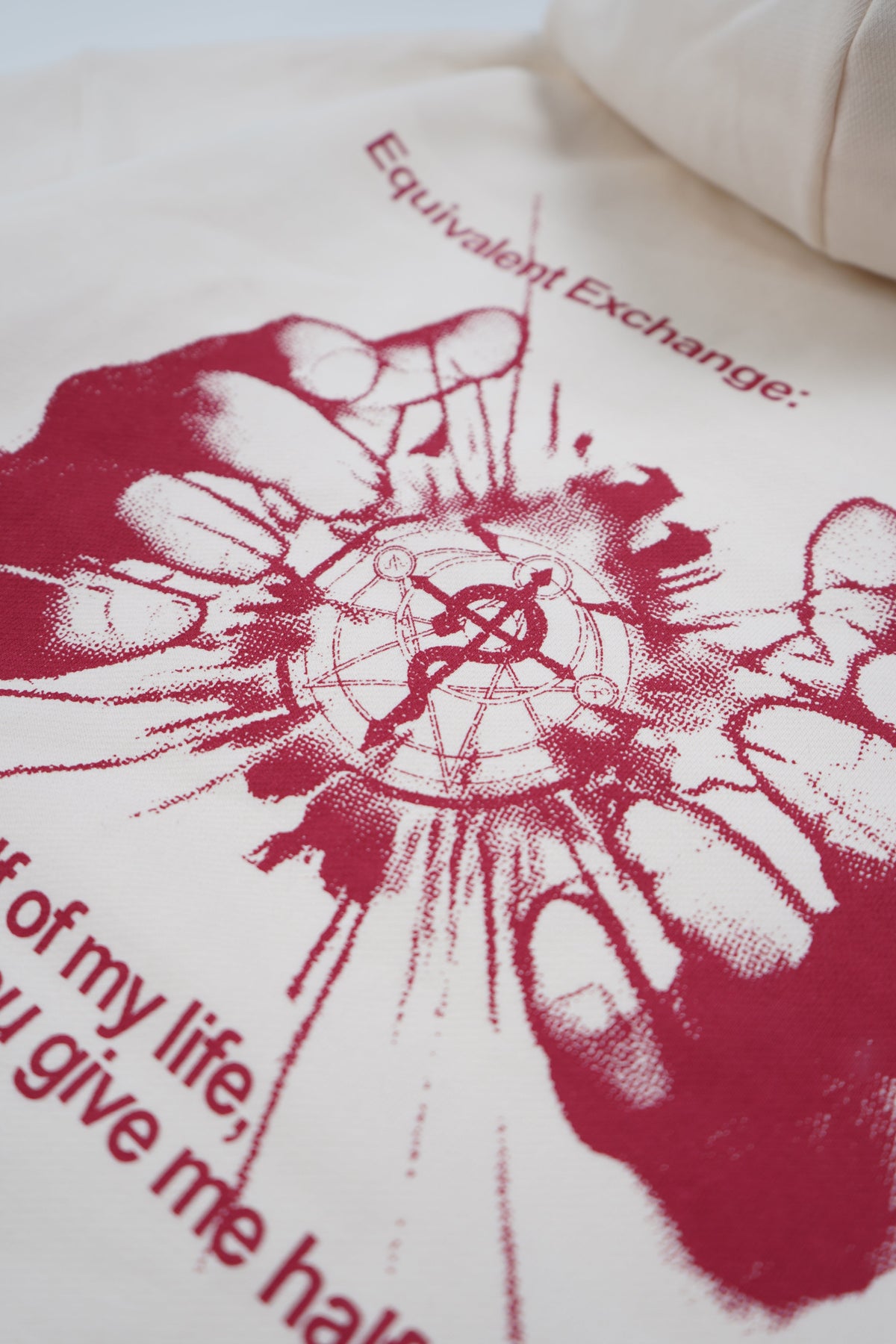 White pillow with red graphic design and text on a white background