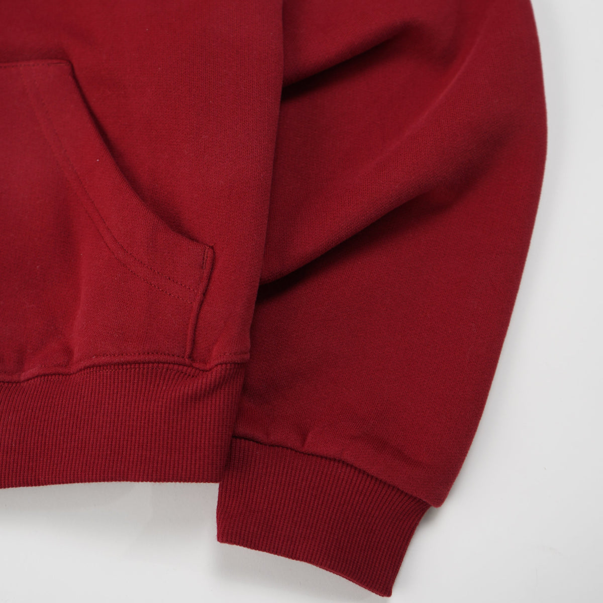 Red sweatshirt with a brand logo on a white background