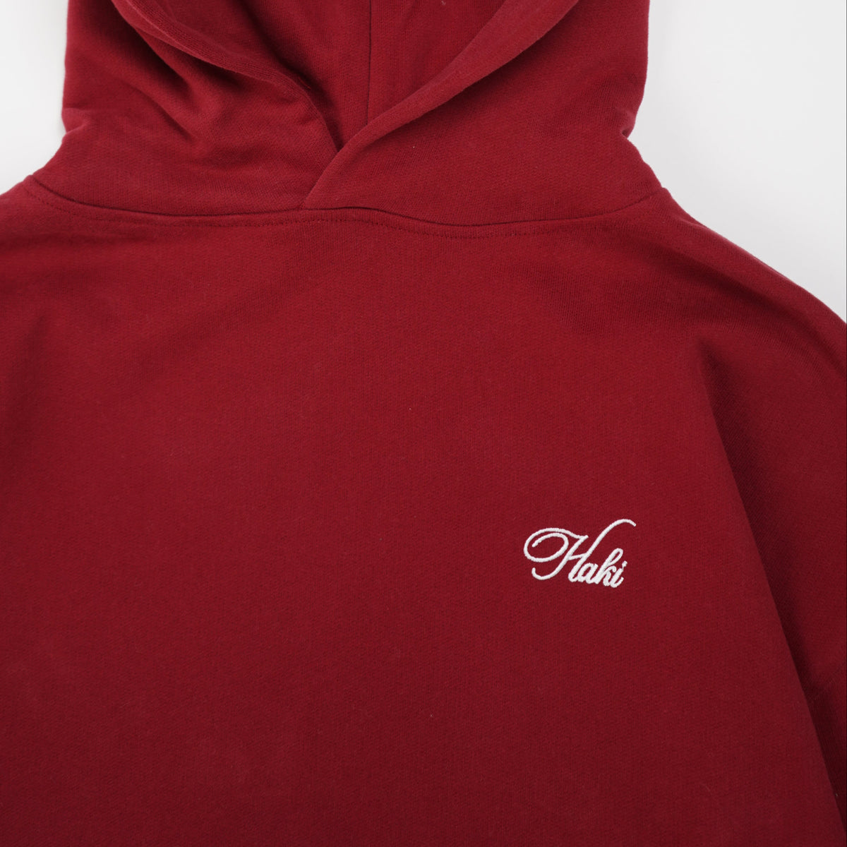 Red hoodie with a brand logo on a white background