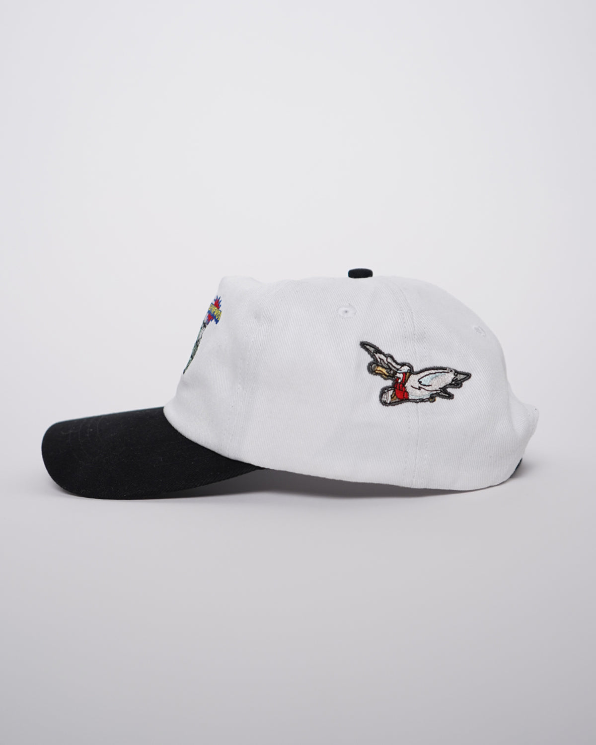 Big News! Hat in white with black brim, side view showing embroidered flying bird graphic