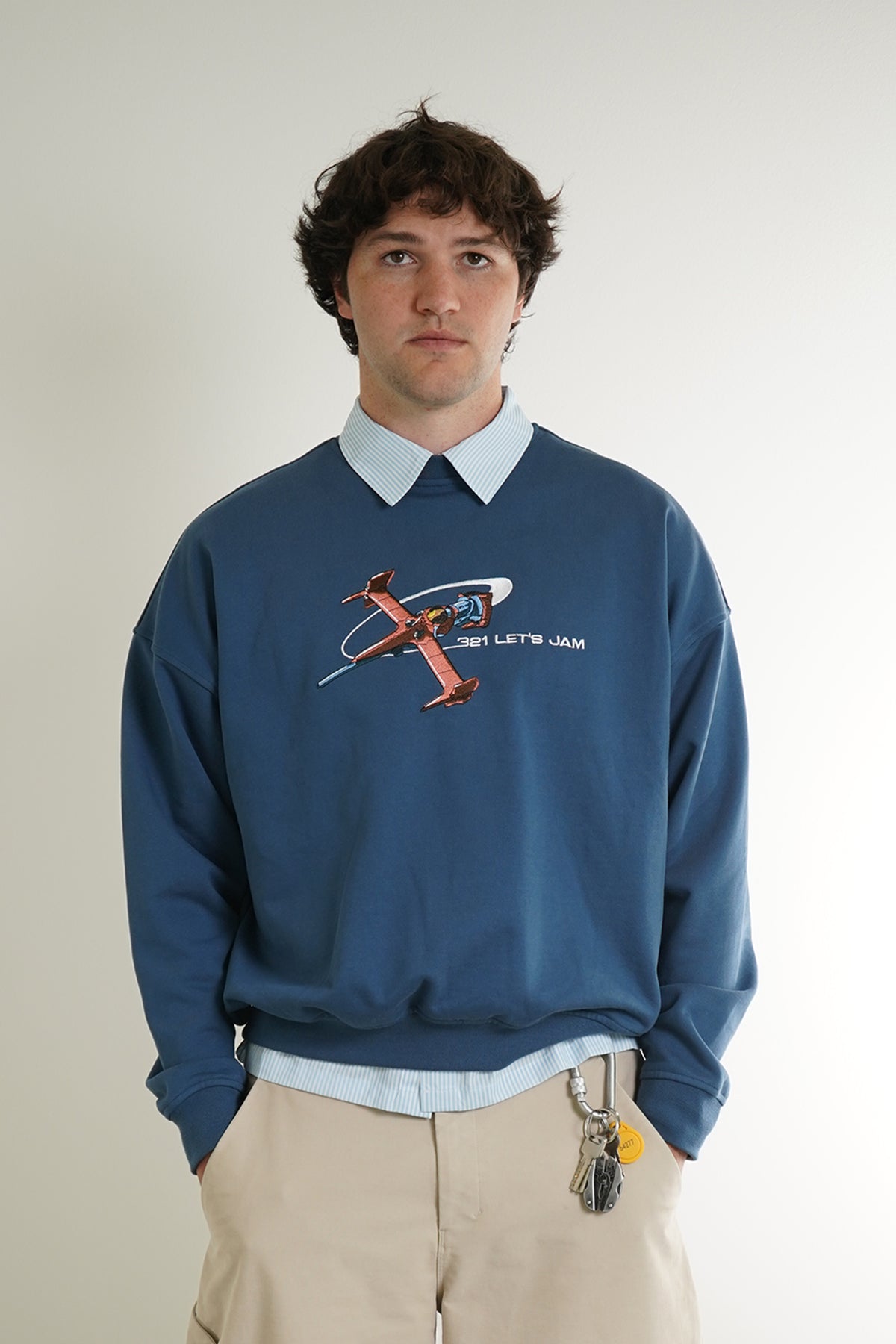 Blue Let's Jam Crewneck with embroidered spaceship and 321 LET'S JAM text, front view on model