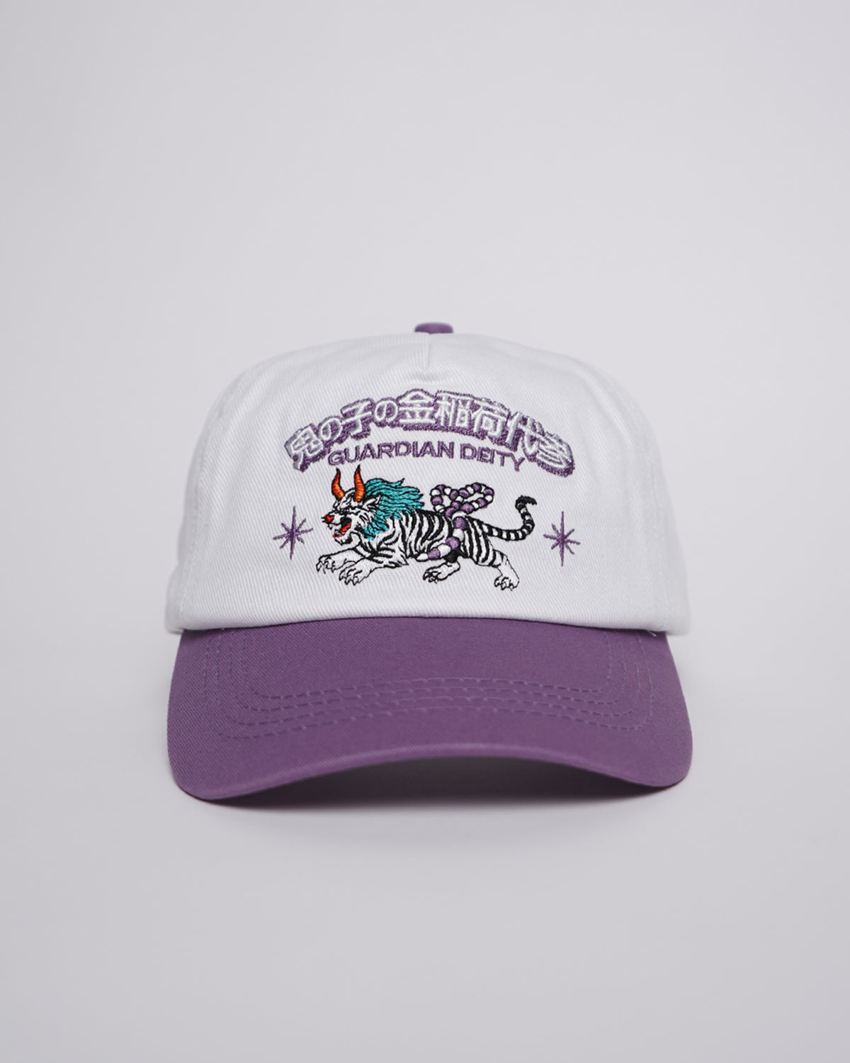 Guardian Deity Hat in white and purple with embroidered mythical creature graphic, side angle view